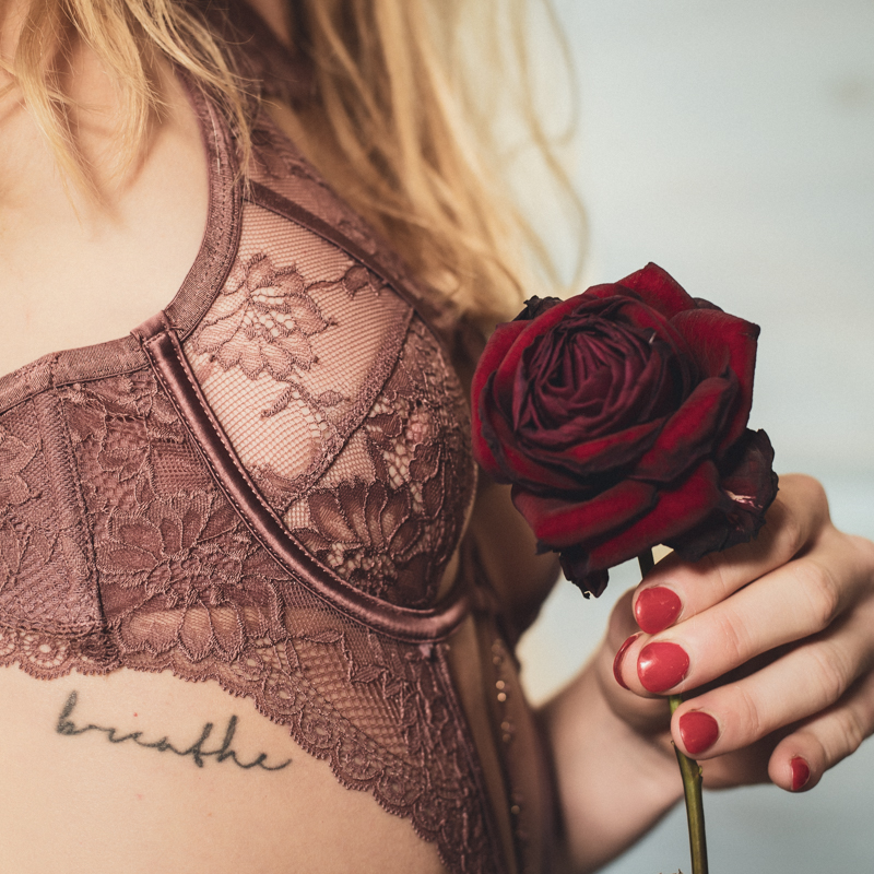 Tantra Intimacy Liberation Powerful woman in sexy lingerie holds a rose with painted nails Hands holding a candle in flame Phoenix Journey Tantra Gent Ghent Belgium